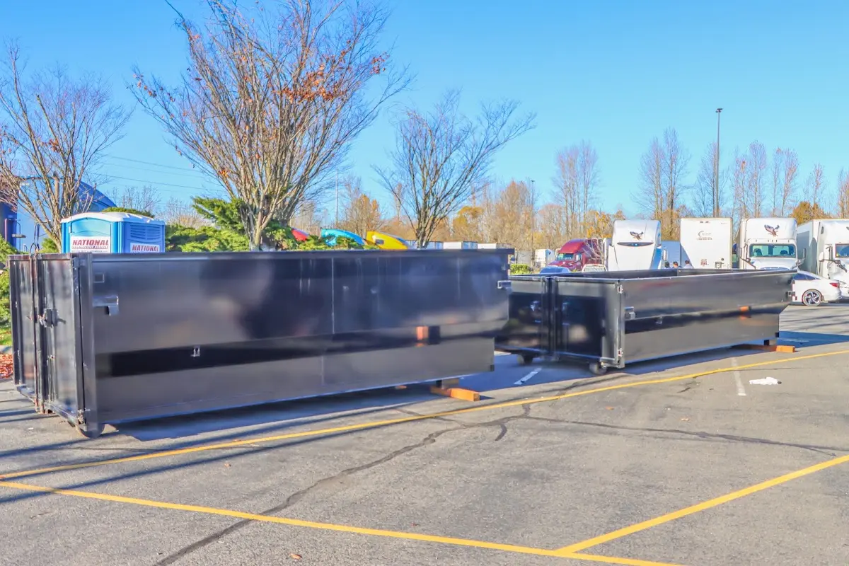 Professional dumpster rental service with roll-off container on residential driveway in Waukesha